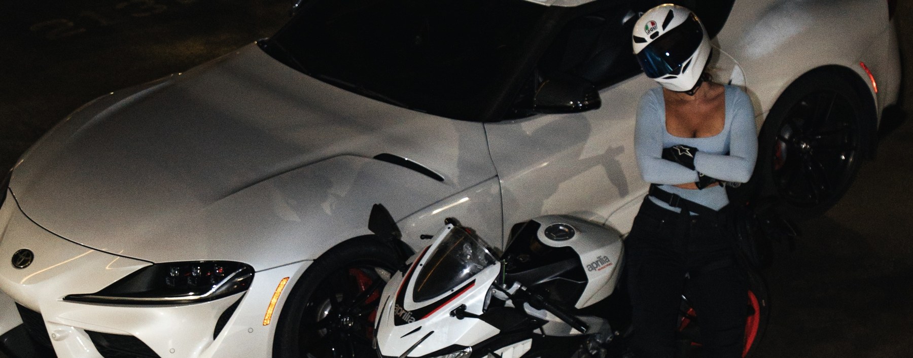 Bella with a car and motorcycle in a parking garage