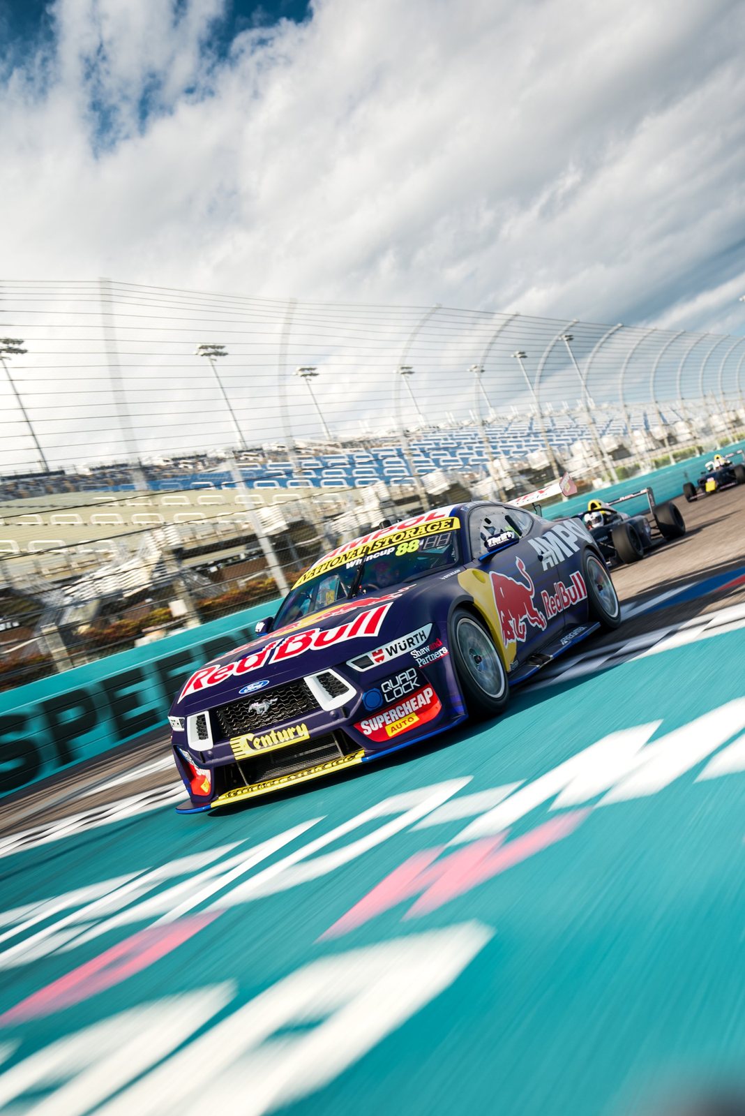 Red Bull Ford Mustang Supercar racing past the grandstands at Homestead
