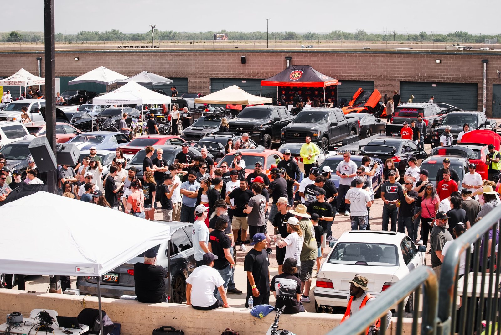 Packed car show crowd in the paddock at Pikes Peak International Raceway, Fountain, Colorado