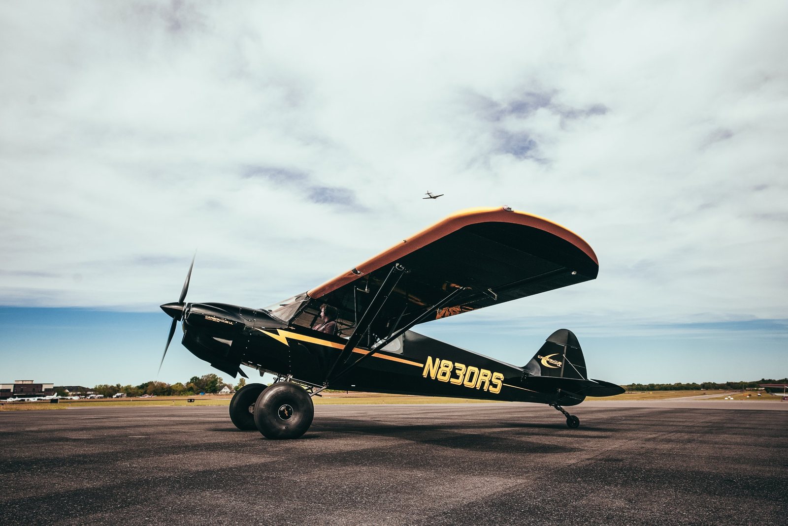 Black and gold Carbon Cub on the ramp under a big sky